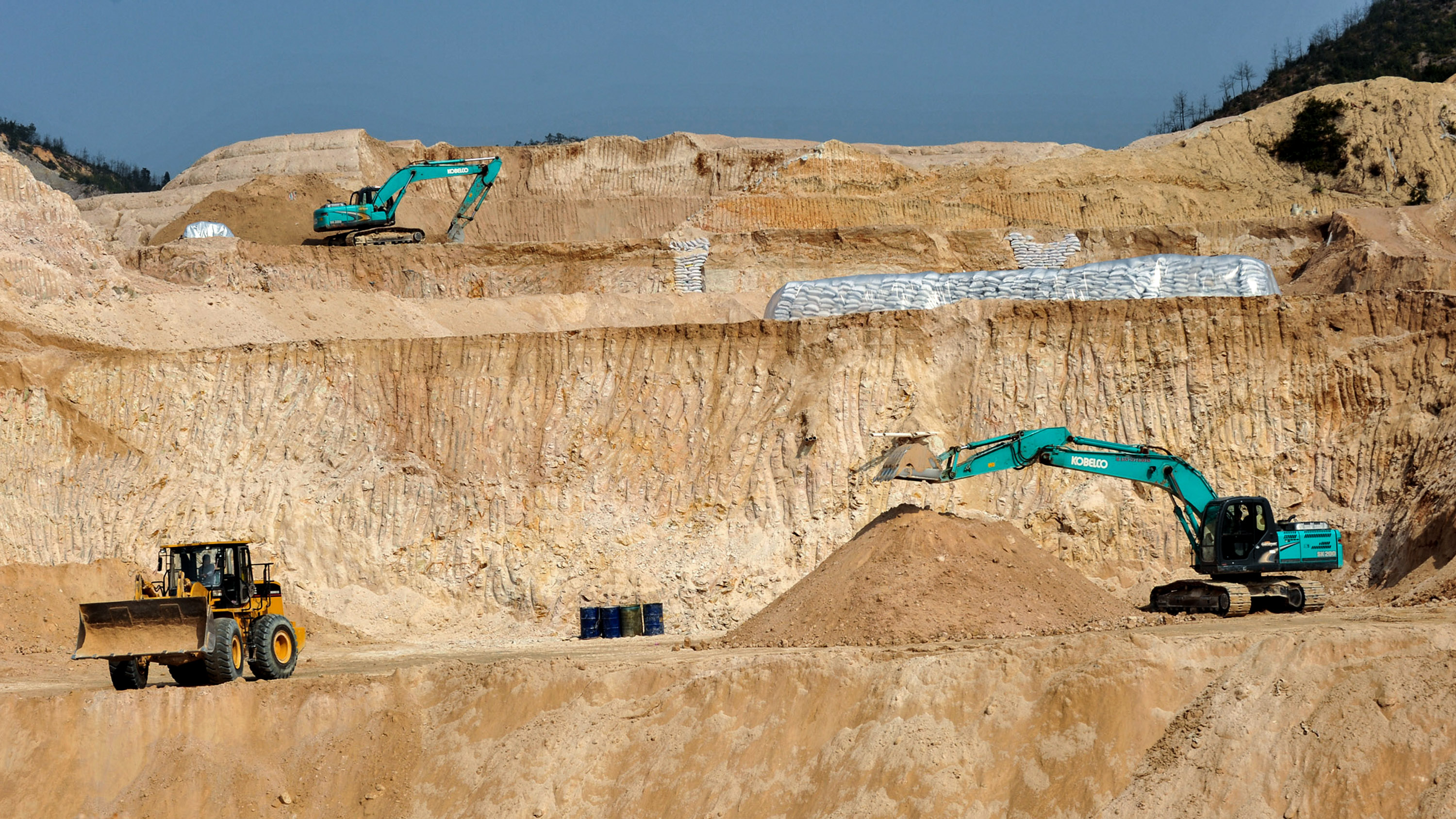machines dig in a rare earth mine in Ganxian county