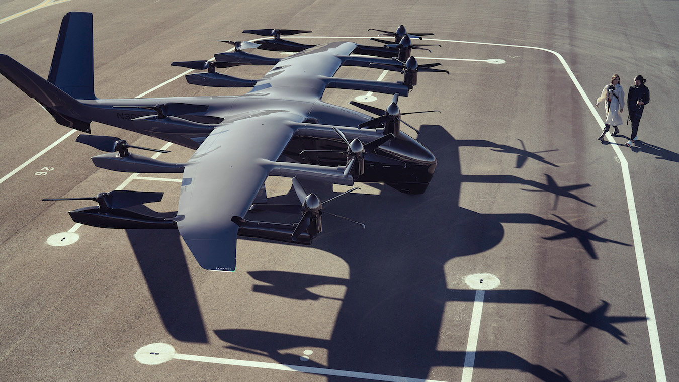 two people walk toward the Archer Midnight on the tarmac