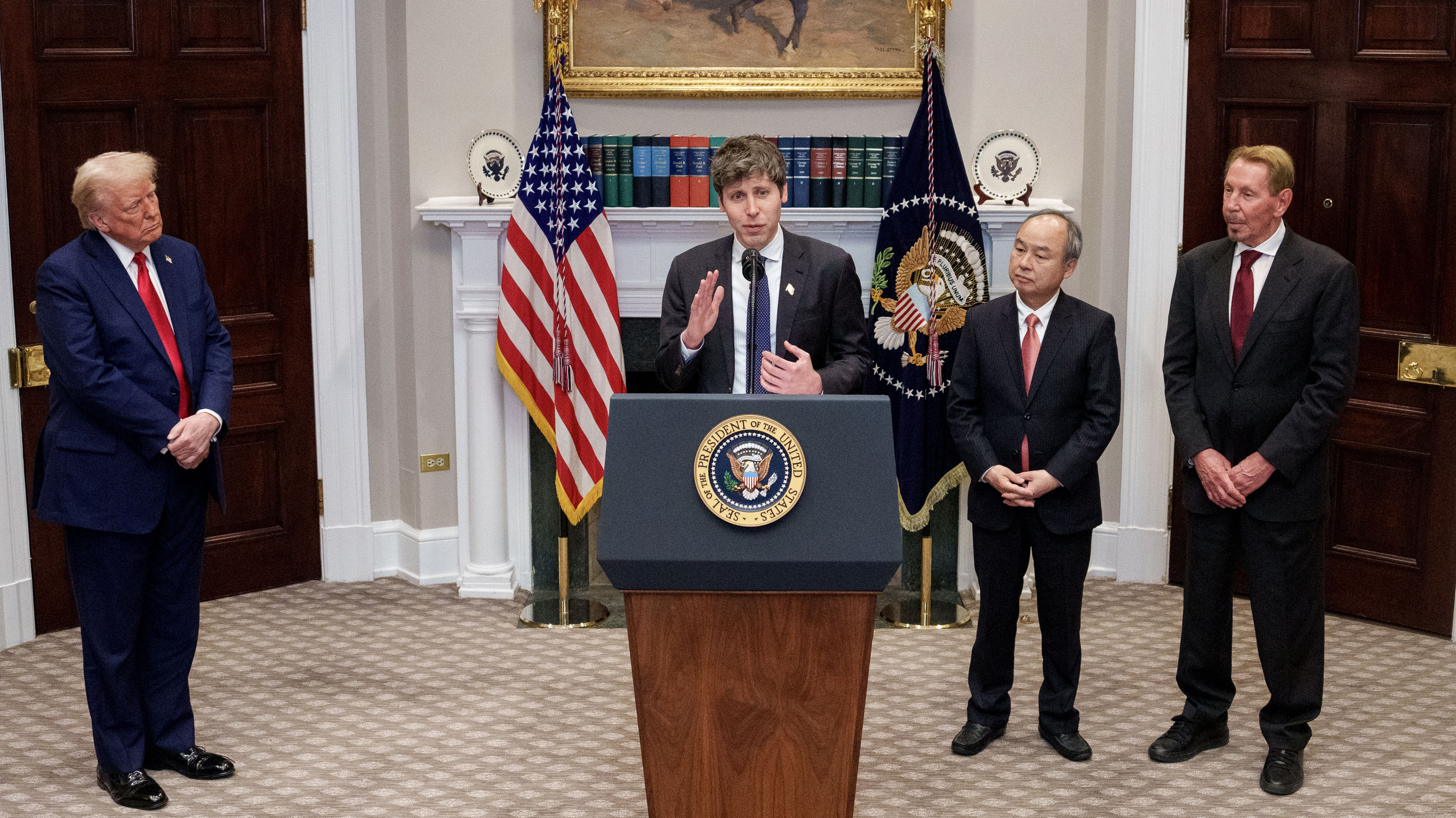Sam Altman, accompanied by U.S. President Donald Trump, Oracle CTO Larry Ellison (R), and SoftBank CEO Masayoshi Son (2nd-R) speaking at the podium in the Roosevelt Room of the White House