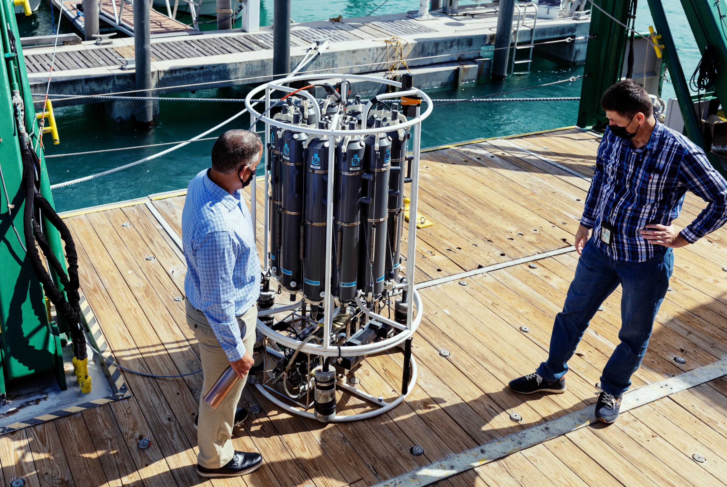 Denis Volkov and Pedro Pena look at equipment
