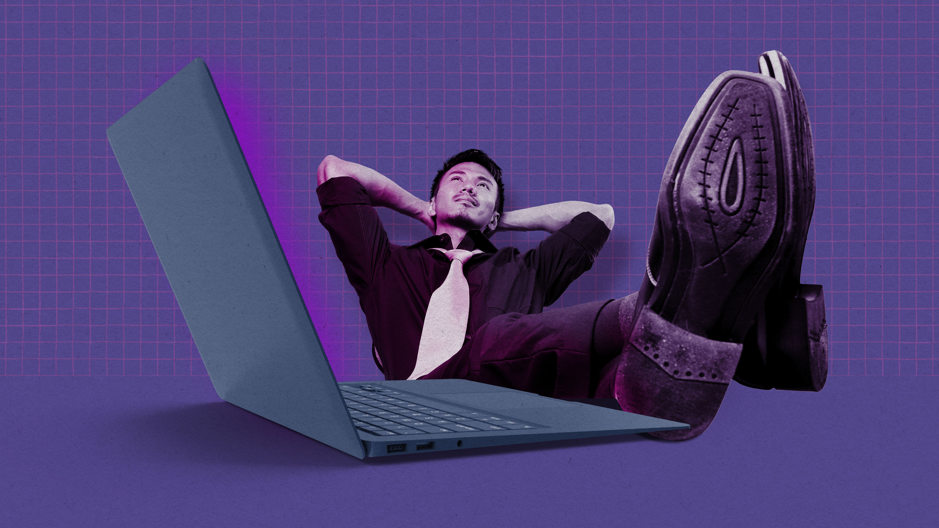 man with feet up and hands behind head daydreams while his laptop glows